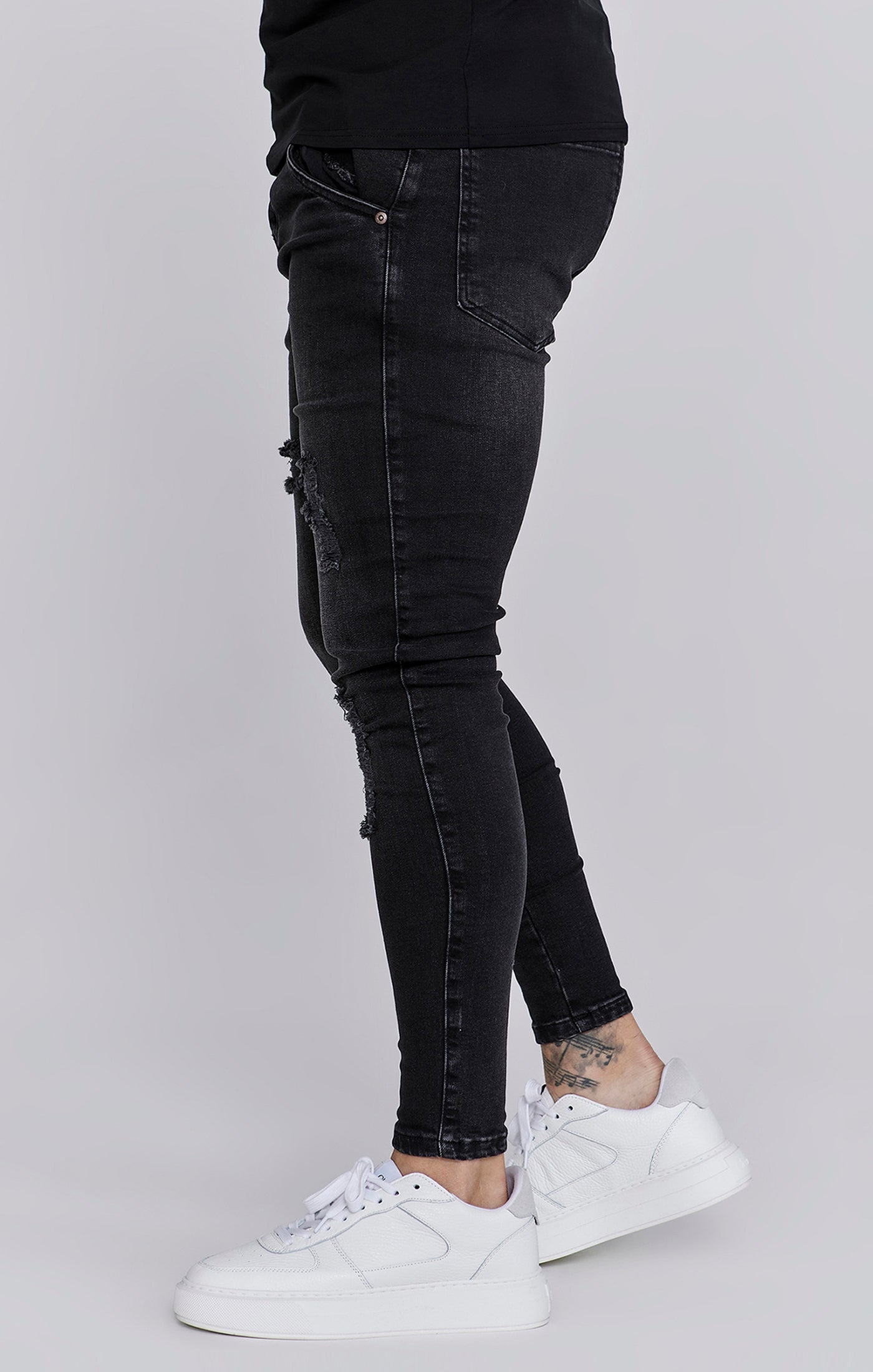 Distressed Skinny Jeans in Black Jeans SikSilk