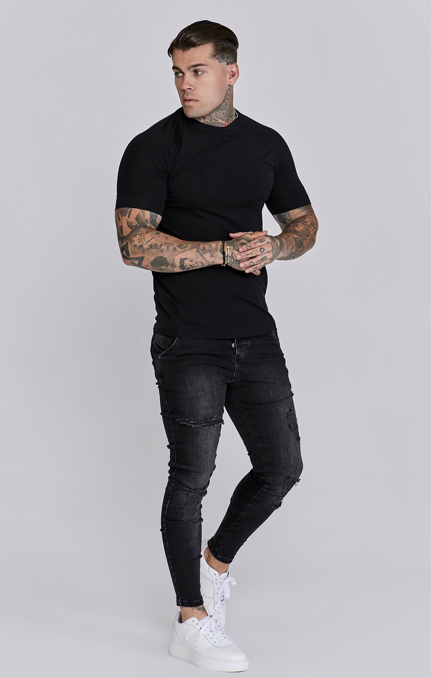 Distressed Skinny Jeans in Black Jeans SikSilk